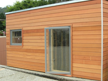 Redwood bevel siding on a rustic two storey home.